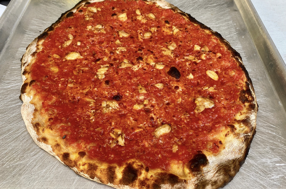 A New Haven Style Apizza, heavy on the tomato sauce, light on the cheese, with a nice charred crust.