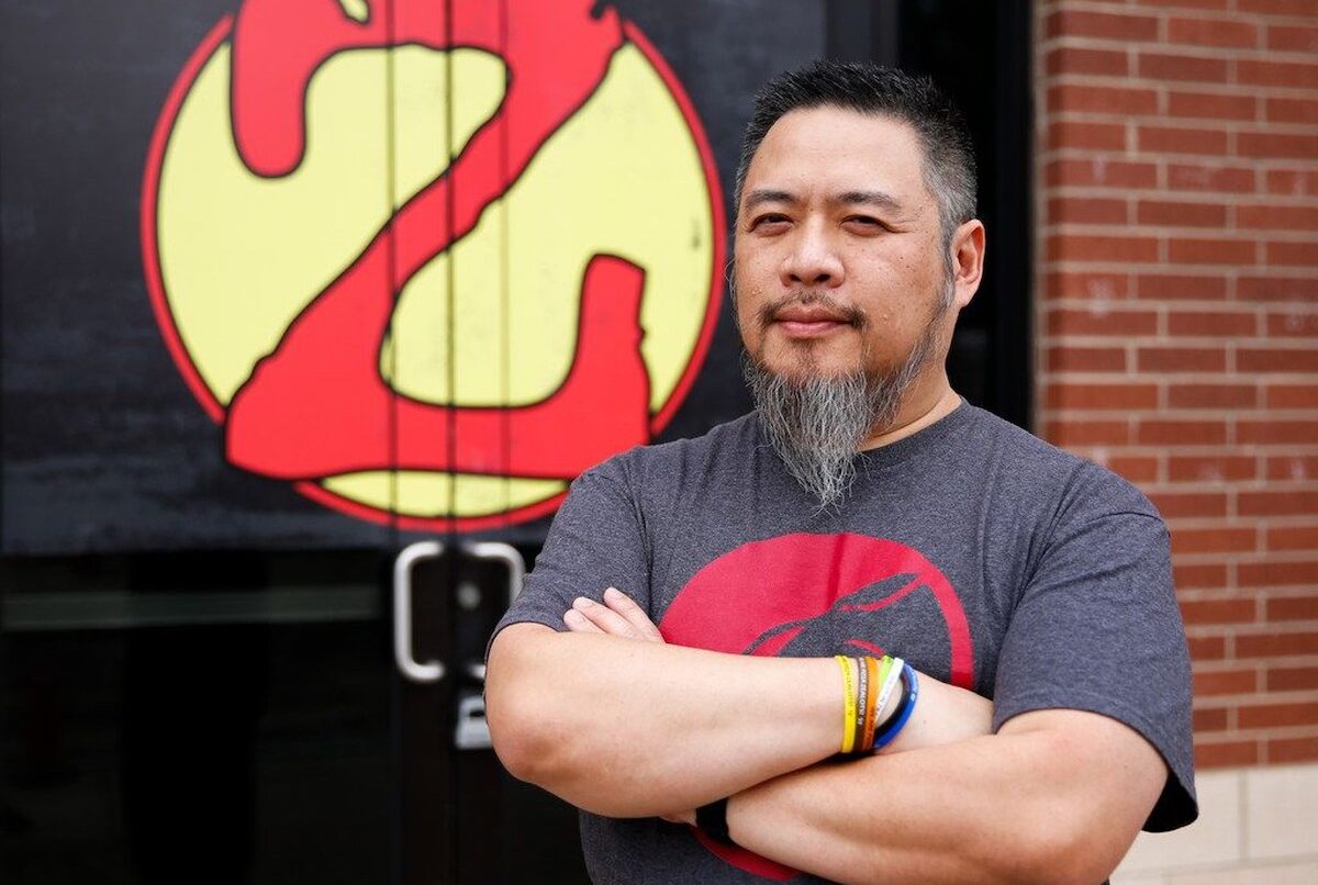 Khanh Nguyen, founder of Zalat Pizza, a 30-unit chain out of Dallas, stands in front of his company's logo: a "Z" styled like the Superman symbol.