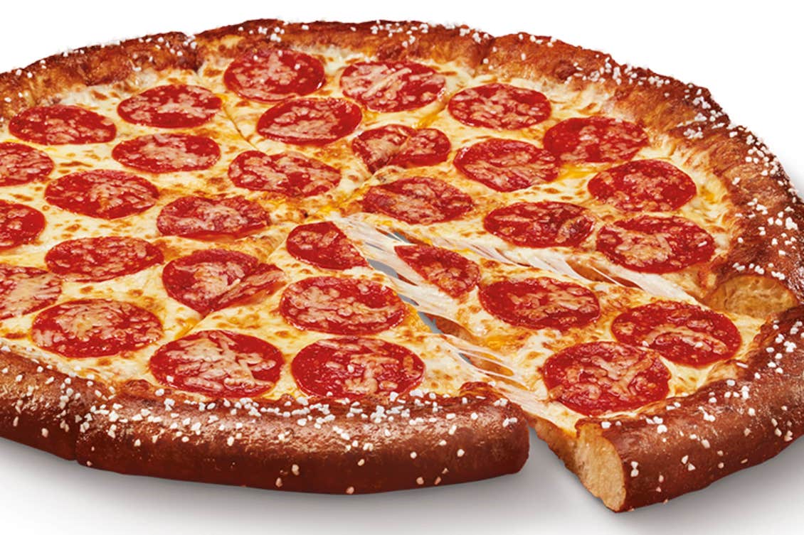This photo shows a whole pepperoni pizza with one slice pulled out slightly.