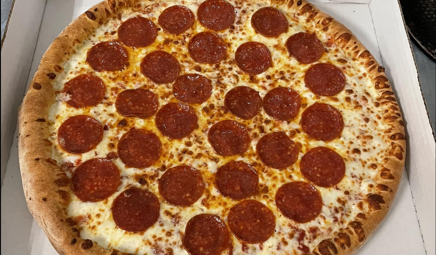 A pepperoni pizza with a robust, slightly charred crust.