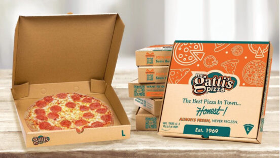 This photo shows an opened pizza box with a pepperoni pizza inside as well as another closed pizza box next to it.