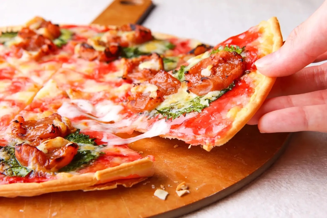 This photo shows a slice of the Umegherita being removed from a whole pie.