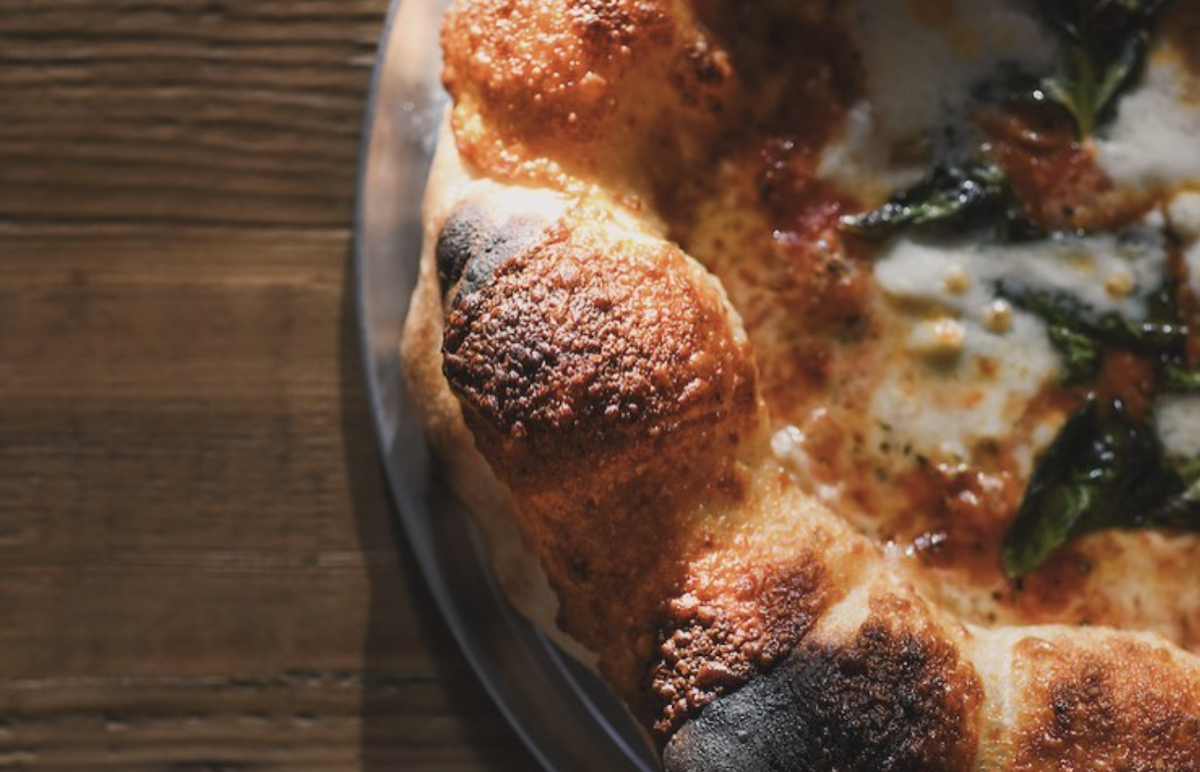 A close up of a Neapolitan-style, puffy crust.