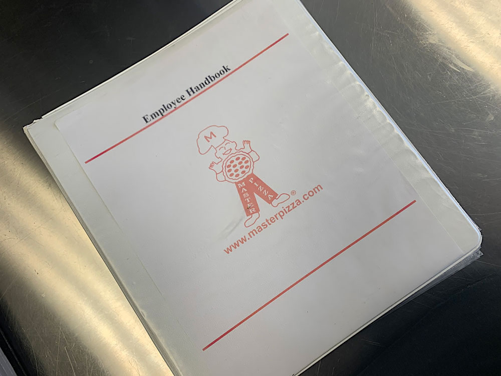 This photo shows the operations handbook for Master Pizza.