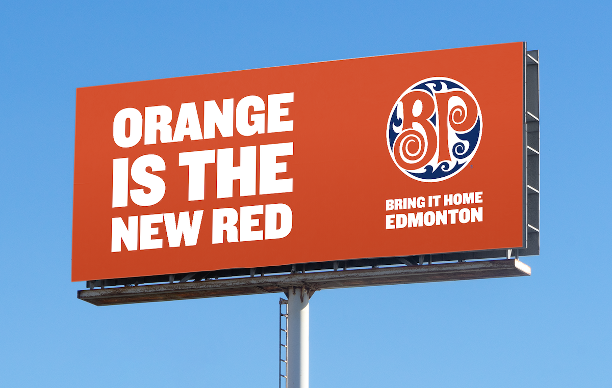 A billboard that says "Orange is the New Read" with Boston Pizza's logo on the other side.