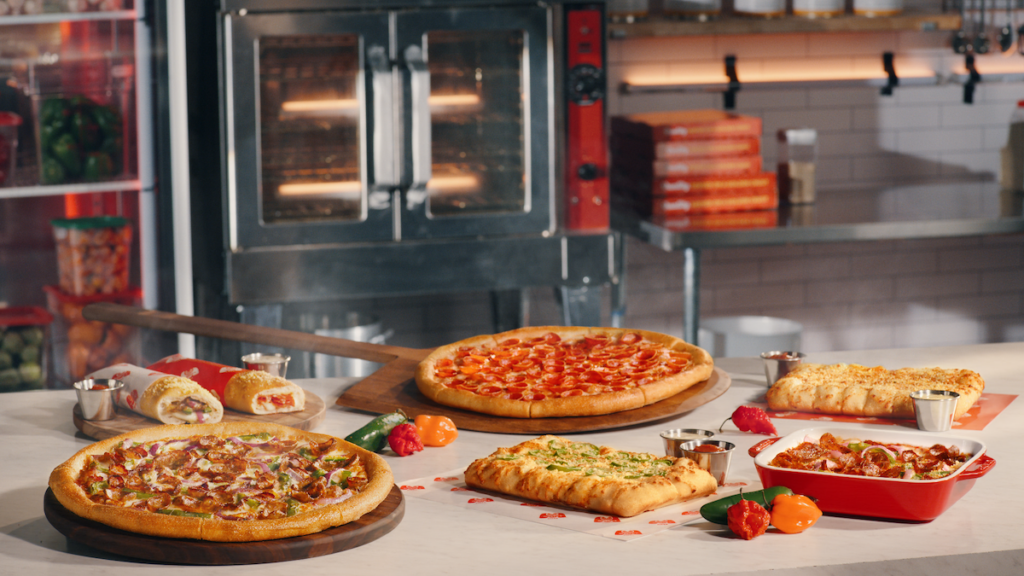 A spread of new menu items from Marco's Pizza, including pizzas and sides.