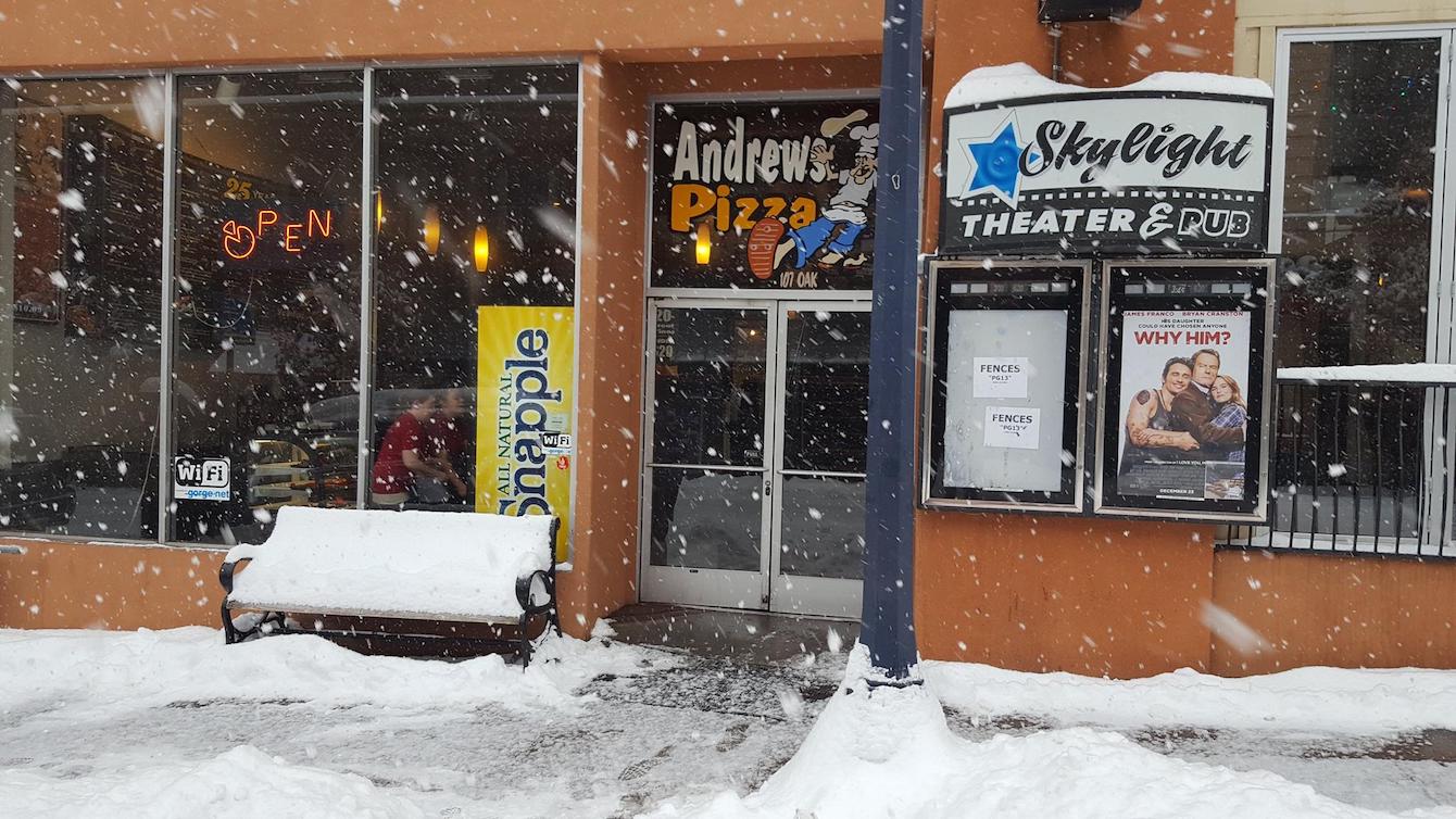 This photo shows the exterior of Andrew's Pizza on a snowy day.