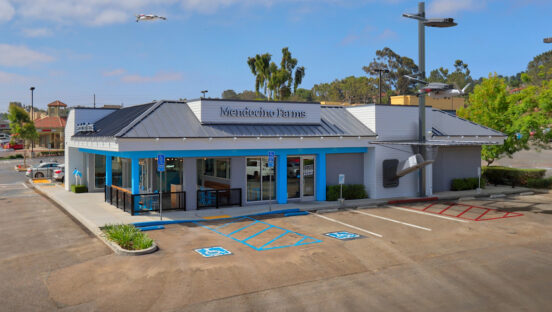 A restaurant storefront with a drone dock out front.