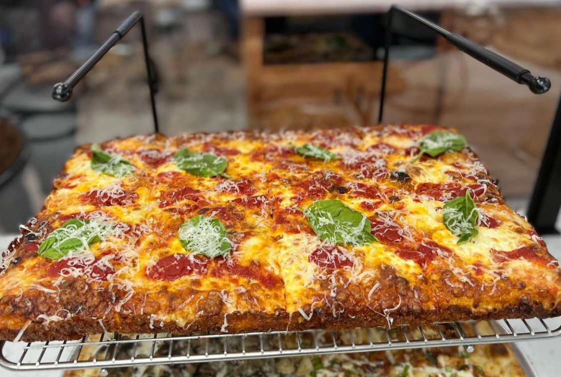 This photo shows a Sicilian pizza on a rack at Pizza on the Point.