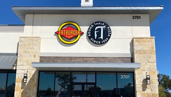 This photo shows the exterior of a co-branded Fatburger and Round Table Pizza location.