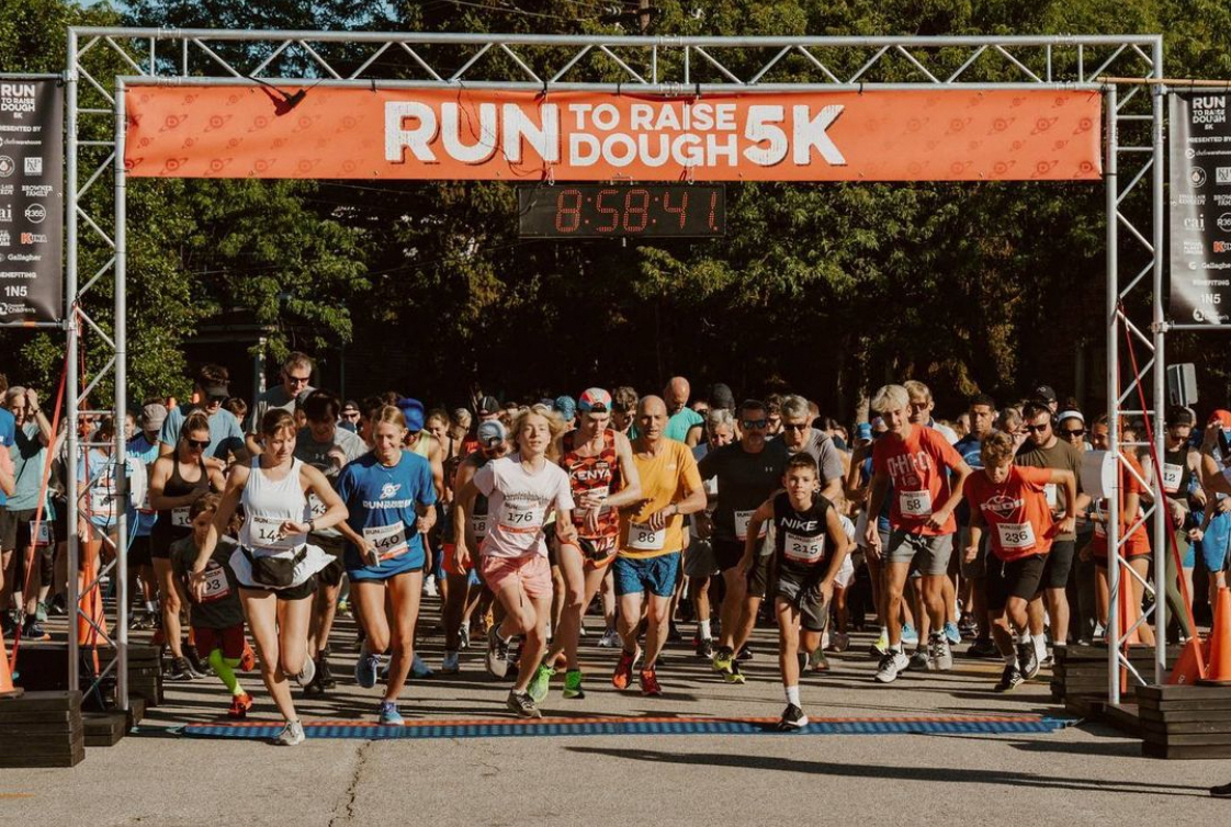 This photo shows a group of runners taking off at last year's Run to Raise Dough event in Cincinnati.