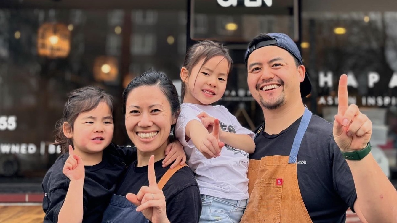 This photo shows Natalie and Aaron Truong with their small children in front of Hapa Pizza.