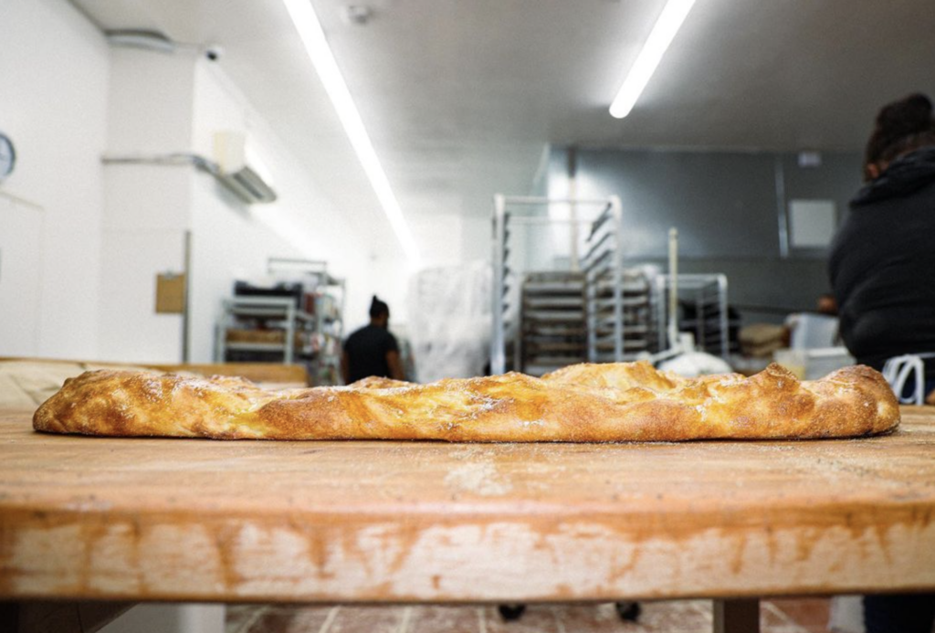a photo of bread on a kitchen counter with the kitchen in the background.