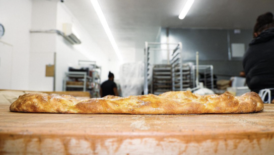 a photo of bread on a kitchen counter with the kitchen in the background.
