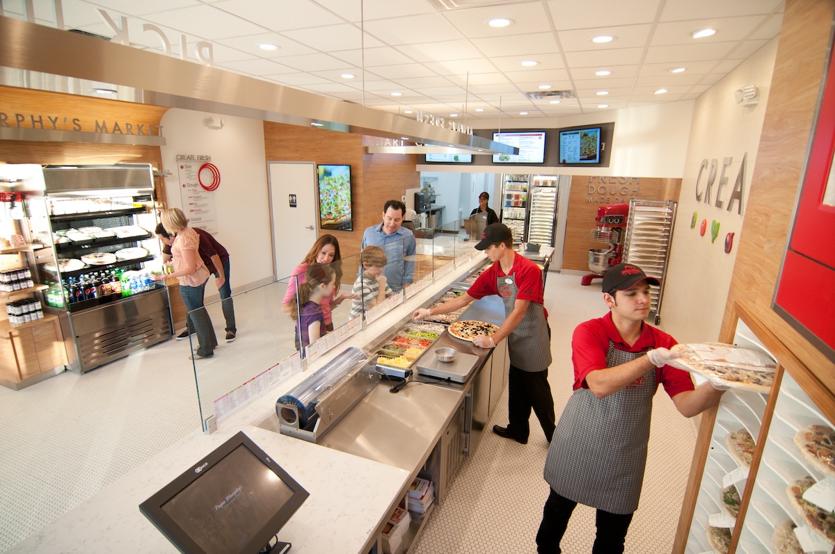 The inside of a Papa Murphy's location, with team members carrying out daily duties.
