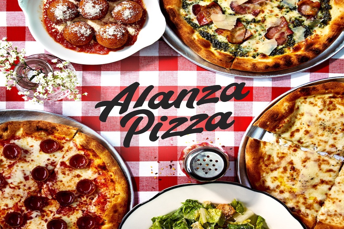 This photo shows several pizzas and a salad on a red checkered tablecloth with the words Alanza Pizza.