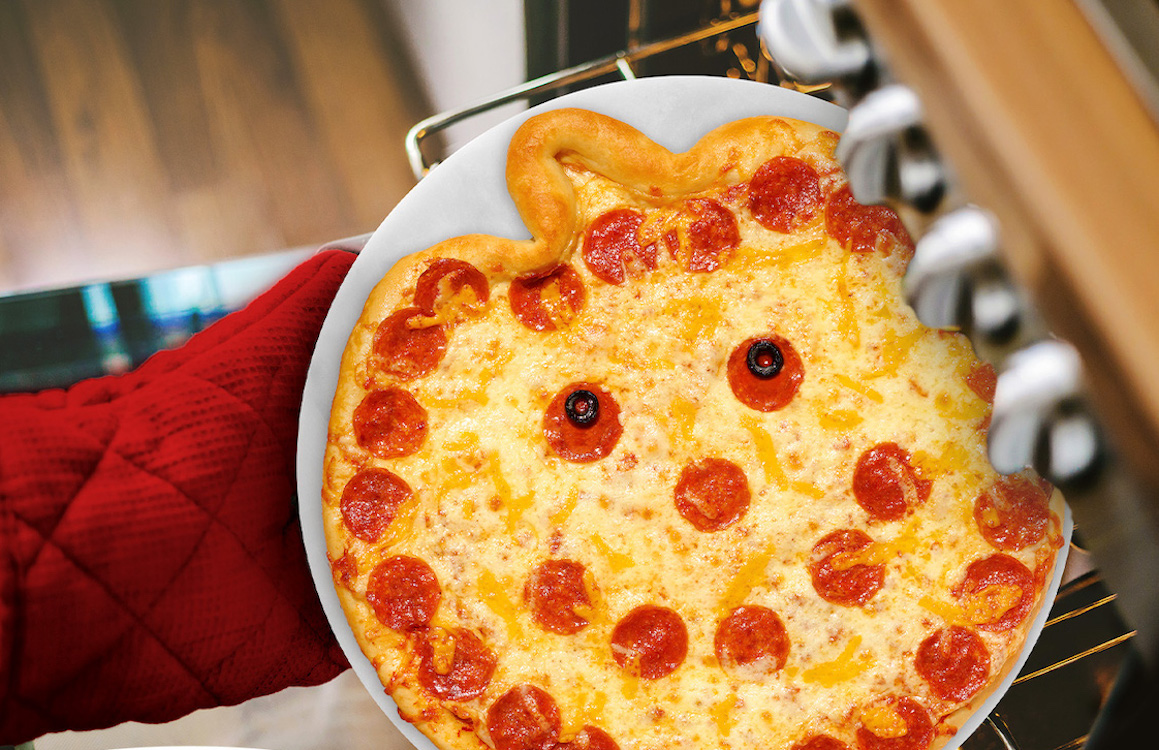 This photo shows the Jack-O pizza with a smile, nose and eyes made from pepperoni slices and little black olives for eyeballs.
