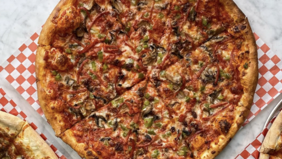 A "windsor-style" pizza featuring shredded pepperoni and canned mushrooms