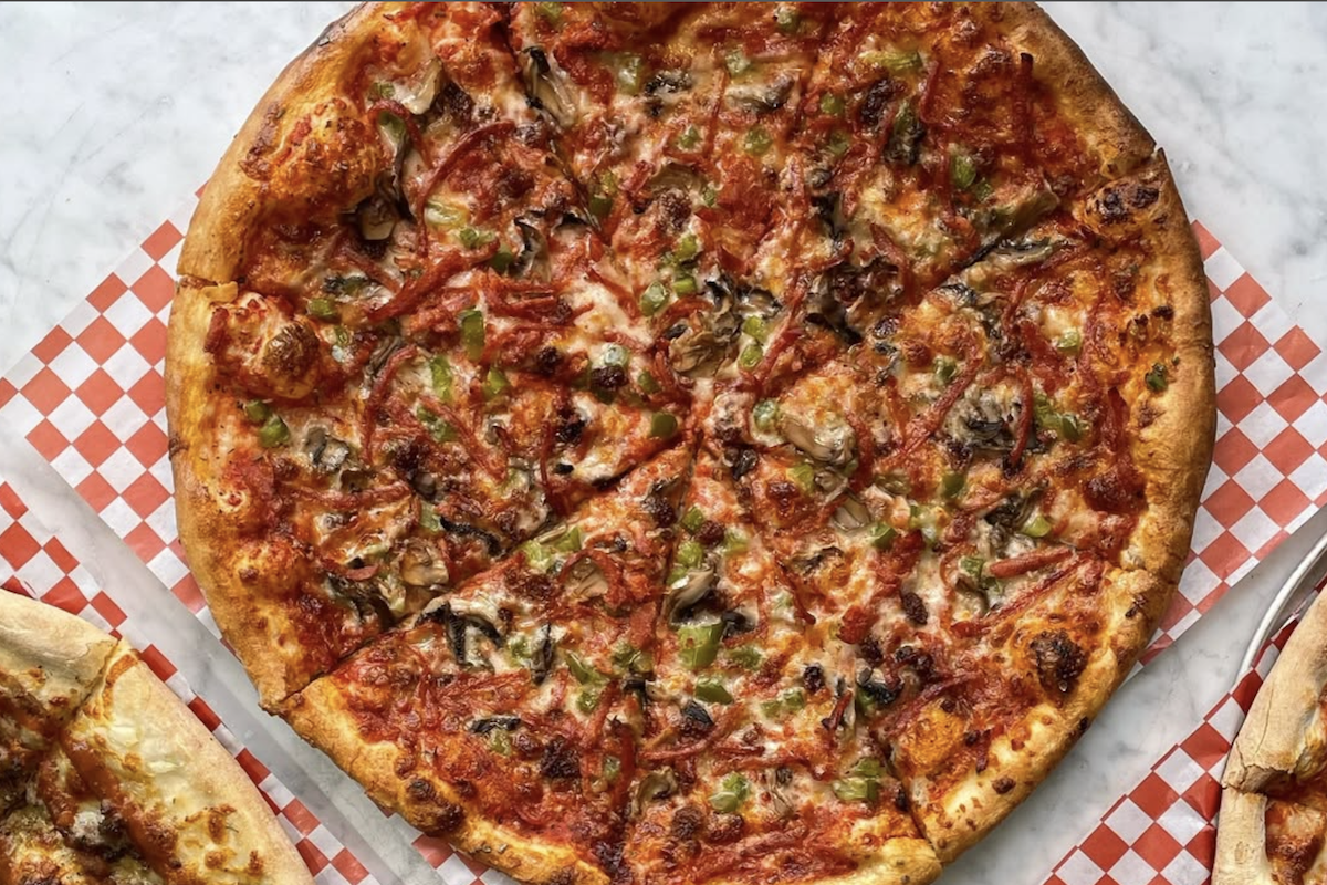 A "windsor-style" pizza featuring shredded pepperoni and canned mushrooms
