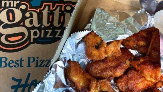 This photo shows an order of chicken wings placed alongside a Mr Gatti's delivery box.