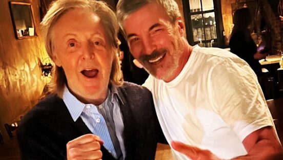 This photo shows Paul McCartney smiling and making a fist while standing to a happy-looking Mark Iacono at Lucali.