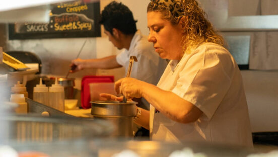 This photo shows Jackie Mazza at work in the kitchen at DeeDee's Pizzeria.
