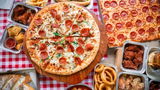 This photo shows a variety of pizzas with different toppings offered at Manny & Olga's.