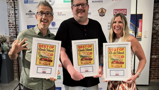 Three individuals stand holding "Best of Rhode Island" awards.