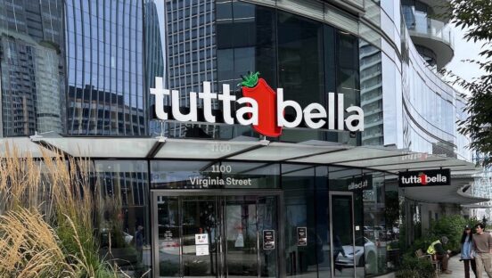 This photo shows the exterior of the new Tutta Bella location, with an ultra-modern look and lots of windows.