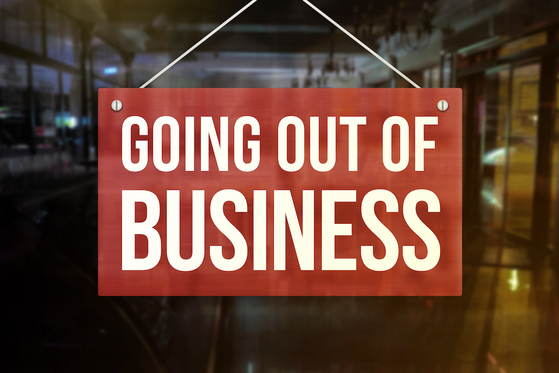 This photo shows a restaurant's window with a sign that reads "Going Out of Business."