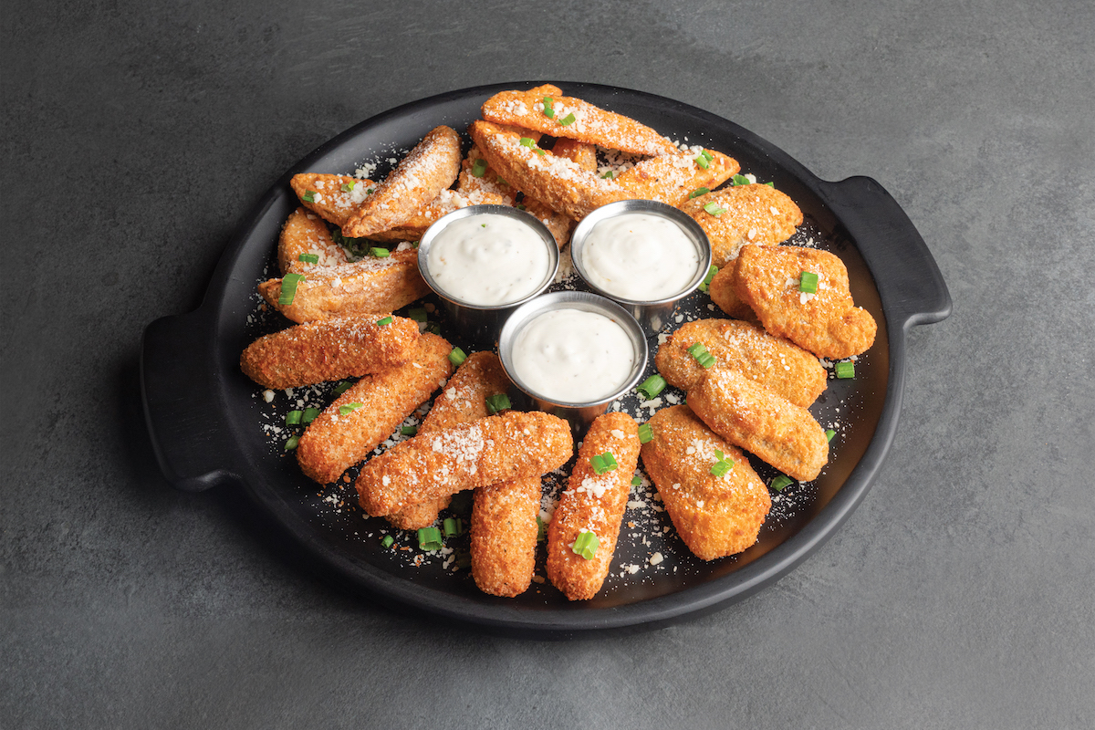 a platter of shareable appetizers with ranch cups in the middle.