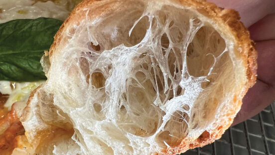This photo shows the inner structure of a perfectly baked pizza crust.