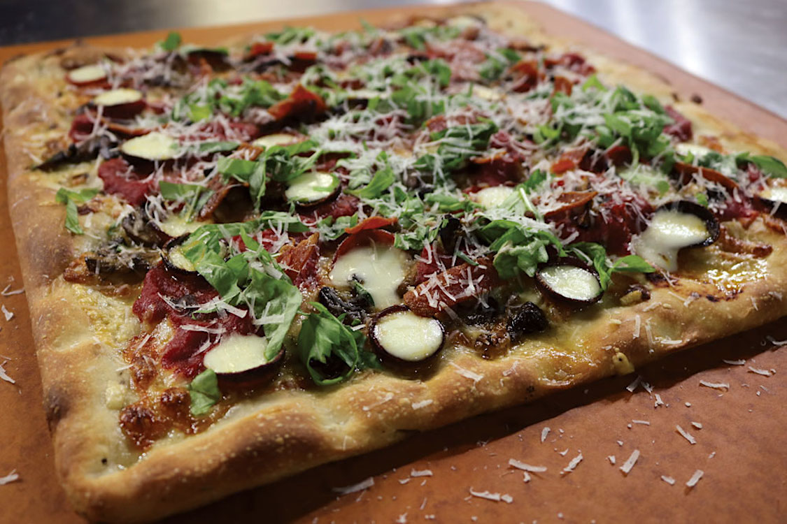 This photo shows the Rosemary Sicilian Grandma Pizza described in the recipe.