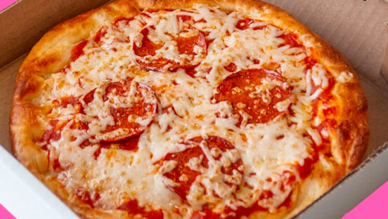 This photo shows a round pizza with cheese and plant-based pepperoni from Odd Burger.