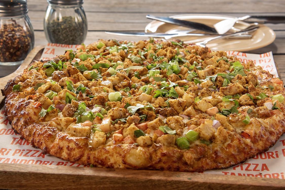 This photo shows the Curry Chicken pizza from Tandoori Pizza.
