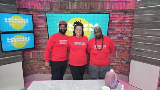 This photo shows the three owners of Certified Pies, all wearing red shirts branded with their logo, standing in a TV station side by side.