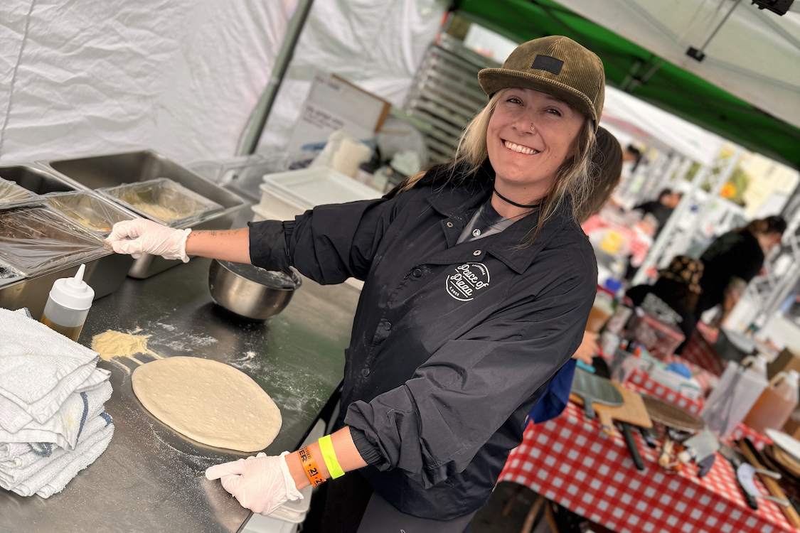 This photo shows Mel Fucilla working in her pizza-making tent at an event.