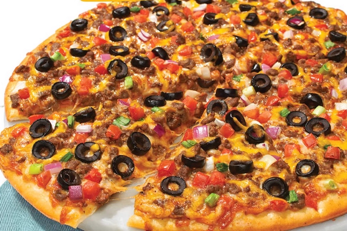 This photo shows the Taco Grande pizza with beef, tomatoes, black olives, cheese, black beans and salsa.