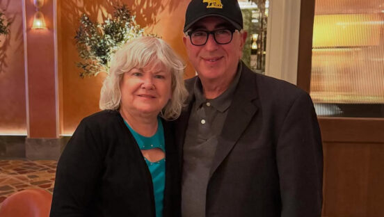 This photo shows Paulie and Mary Ann Giannone standing closely together and looking like a happy couple.