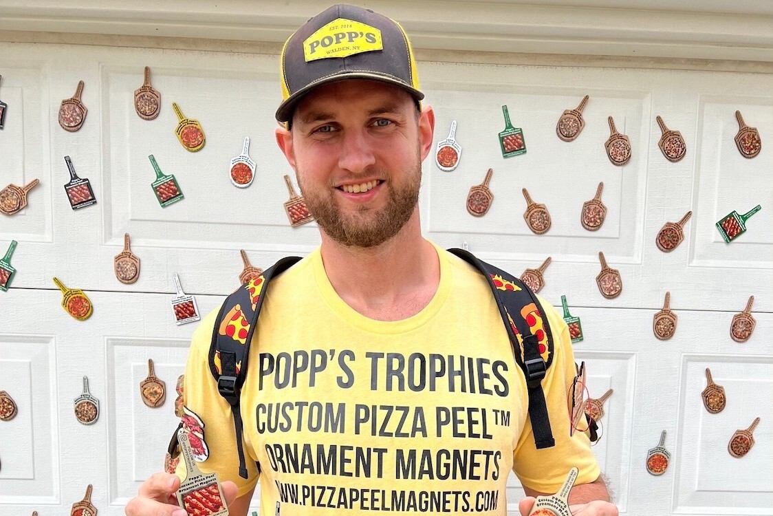 This photo shows Todd DeGroat wearing a yellow t-shirt advertising his business.
