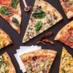 This photo shows a variety of pizza slices from Wiseguy Pizza.
