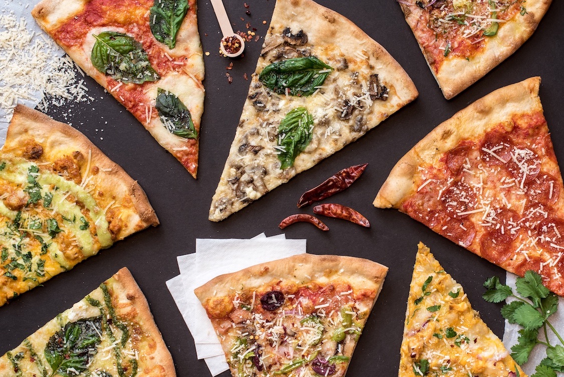 This photo shows a variety of pizza slices from Wiseguy Pizza.