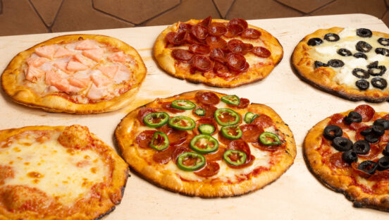This photo shows a variety of pizza bagels from Bagizza.