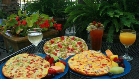 This photo shows a wide selection of pizzas, plus cocktails and white wine, at U.S. Pizza Co.