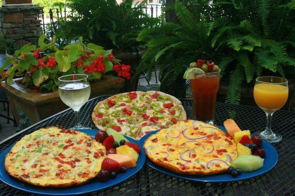 This photo shows a wide selection of pizzas, plus cocktails and white wine, at U.S. Pizza Co.