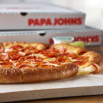 This photo shows Papa Johns' Epic Stuffed Crust Pizza with cheese oozing from the crust.