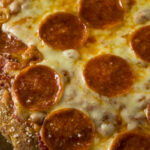 This photo shows a Homemade Pepperoni Pretzel Crust PIzza with Salt and Cheese