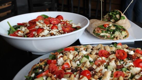 This photo shows a bowl of salad, a salad pizza and a salad wrap.