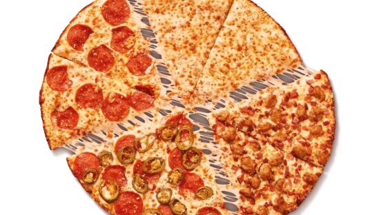 This photo shows a whole pie, cut into slices, of the Fantastic 4 in 1 pizza described in the article.