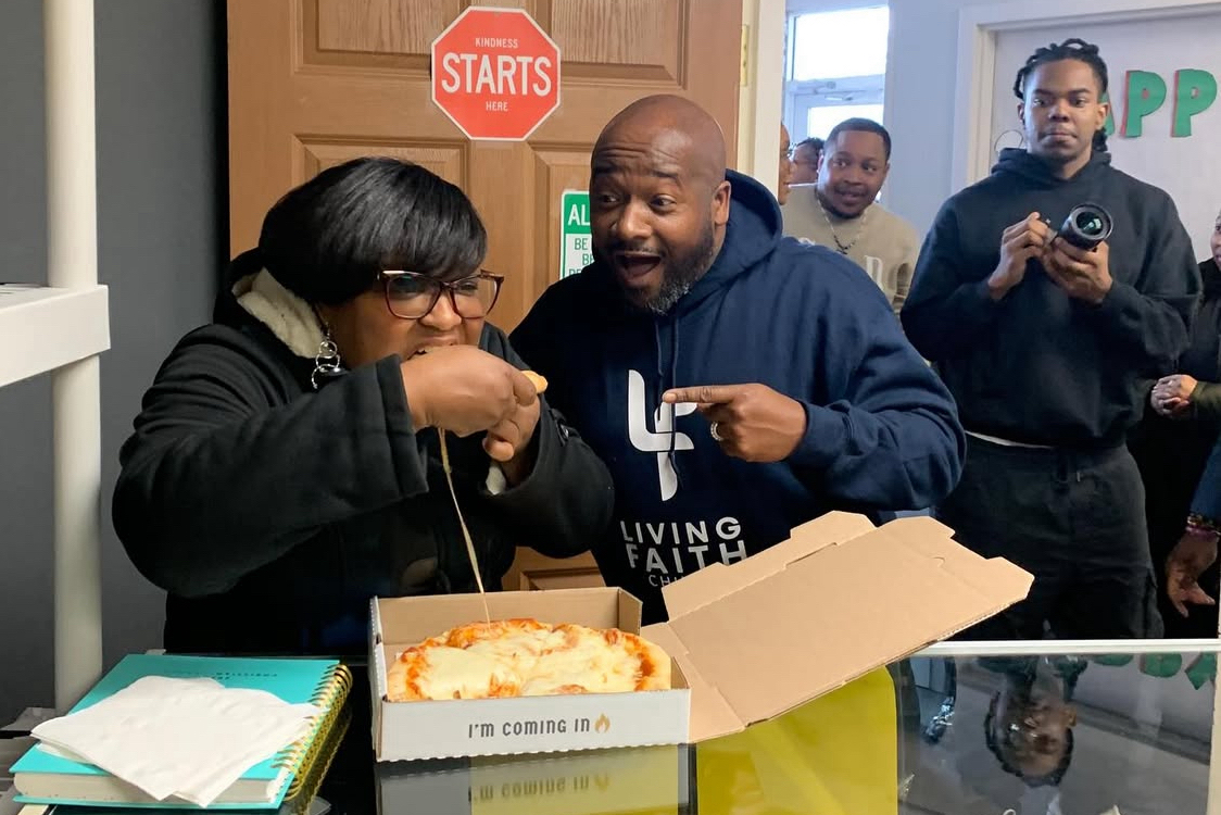 This photo shows Dr. Tuck with one of his church members eating a pizza.